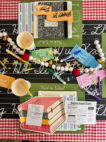 Back to school-themed stationery items on a checkered tablecloth