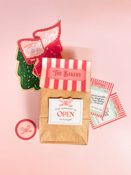 Bakery-themed items including a paper bag, cookies, and tickets on a pink background
